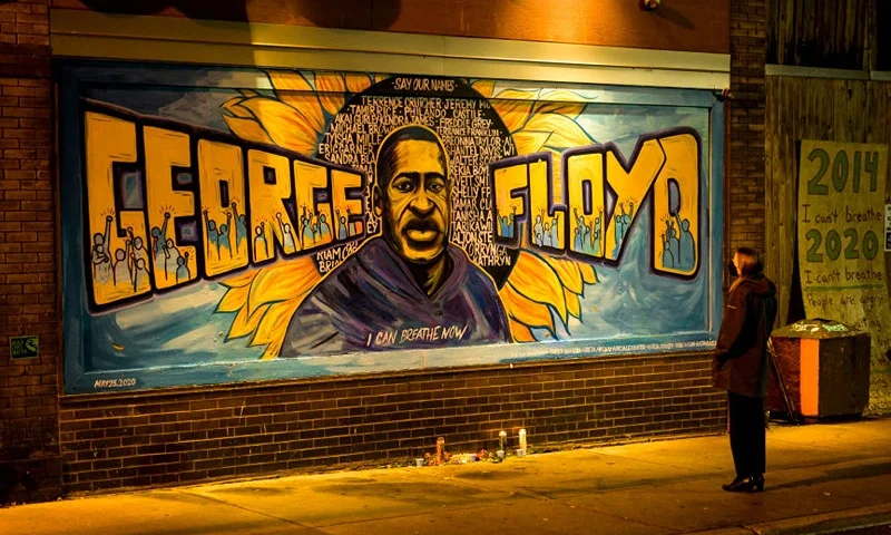 A woman looks at a mural on the wall of Cup Foods during a vigil for George Floyd on May 25, 2022 in Minneapolis, Minnesota. It has been two years since George Floyd was killed by Minneapolis Police. (Photo by Stephen Maturen/Getty Images)