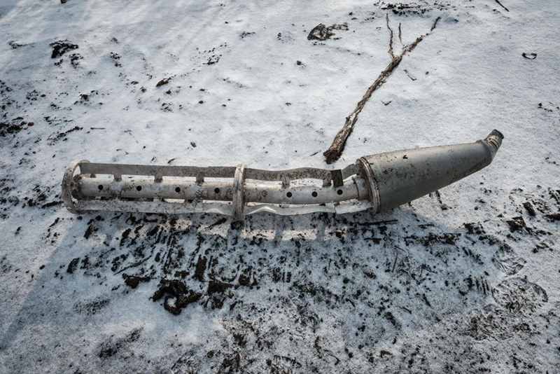 A casing of a cluster bomb rocket lays on the snow-covered ground in Zarichne on February 6, 2023, amid the Russian invasion of Ukraine. (Photo by YASUYOSHI CHIBA / AFP) (Photo by YASUYOSHI CHIBA/AFP via Getty Images)