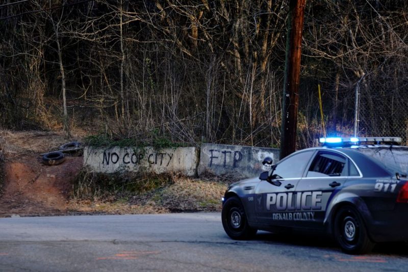 Law enforcement drive past the planned site of a police training facility that activists have nicknamed "Cop City", following the first raid since the death of environmental activist Manuel Teran near Atlanta, Georgia, on February 6, 2023. - Teran was allegedly shot by police on January 18, 2023, during a confrontation as officers cleared activists from a forest, the planned site of a police-training facility. (Photo by CHENEY ORR / AFP) (Photo by CHENEY ORR/AFP via Getty Images)