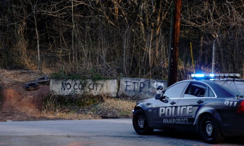 Law enforcement drive past the planned site of a police training facility that activists have nicknamed "Cop City", following the first raid since the death of environmental activist Manuel Teran near Atlanta, Georgia, on February 6, 2023. - Teran was allegedly shot by police on January 18, 2023, during a confrontation as officers cleared activists from a forest, the planned site of a police-training facility. (Photo by CHENEY ORR / AFP) (Photo by CHENEY ORR/AFP via Getty Images)