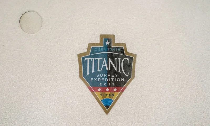 EVERETT, WASHINGTON - JUNE 21: A sticker from a 2019 Titanic survey expedition is seen in a window of the OceanGate offices on June 21, 2023 in Everett, Washington. OceanGate, owner of the missing submersible carrying five people trying to visit the Titanic wreckage in the North Atlantic, operates out of Everett. (Photo by David Ryder/Getty Images)