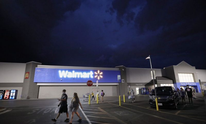 Shoppers walk in the parking lot of a Walmart on August 1, 2020 in El Paso, Texas. The parking lot of the Walmart was the location where a 21-year-old white male shooter allegedly killed 23 people in a racist attack targeting Latinos. August 3rd marks the one-year anniversary of the deadliest attack against Hispanics in modern U.S. history. A number of memorial events are planned amid the COVID-19 pandemic in the Texas city which sits along the U.S.-Mexico border. (Photo by Mario Tama/Getty Images)