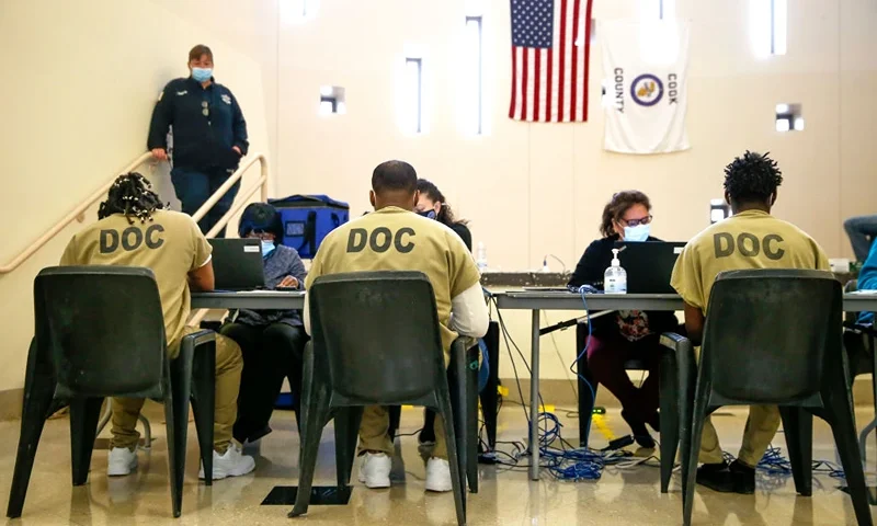 CHICAGO, ILLINOIS - OCTOBER 17: Cook County jail detainees check in before casting their votes after a polling place was opened in the facility for early voting on October 17, 2020 in Chicago, Illinois. It is the first time pretrial detainees in the jail will get the opportunity for early voting in a general election. (Photo by Nuccio DiNuzzo/Getty Images)