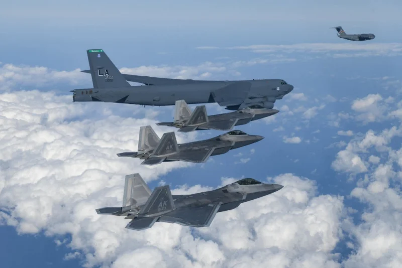 UNDISCLOSED LOCATION, SOUTH KOREA - DECEMBER 20: In this handout image released by the South Korean Defense Ministry, A U.S. B-52H strategic bomber, F-22 fighter jets and C-17 fly over South Korea during the joint air drills on December 20, 2022 at an undisclosed location in South Korea. South Korea and the United States conducted combined air drills, involving a U.S. B-52 strategic bomber and F-22 stealth fighters. The drills took place in the South's air defense identification zone southwest of its southern island of Jeju aimed at bolstering allies' deterrence against evolving North Korean threats. (Photo by South Korean Defense Ministry via Getty Images)