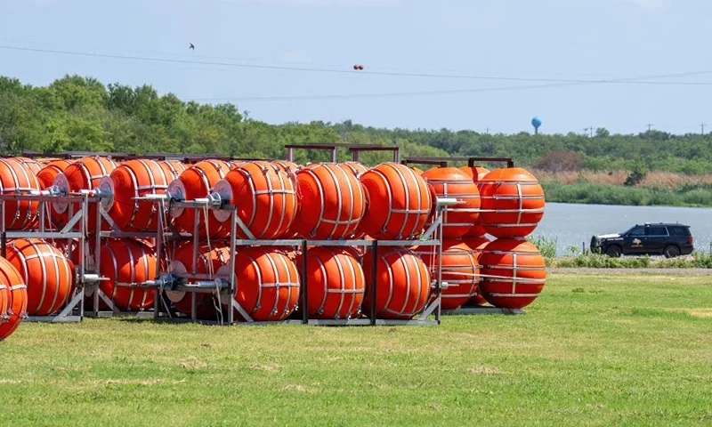 Buoy barriers are prepared for installation during a water-based border operation in Eagle Pass, Texas, on July 9, 2023. A Texas businessman has filed a lawsuit in a bid to stop the state's governor from placing huge buoys in the Rio Grande to block migrants trying to cross the river, the man's lawyer said July 8. "New marine barrier installation on the Rio Grande begins today," Governor Greg Abbott, a Republican, said July 7 on Twitter, in a post that included video of workers unloading huge orange buoys from flat-bed trucks. (Photo by SUZANNE CORDEIRO / AFP) (Photo by SUZANNE CORDEIRO/AFP via Getty Images)