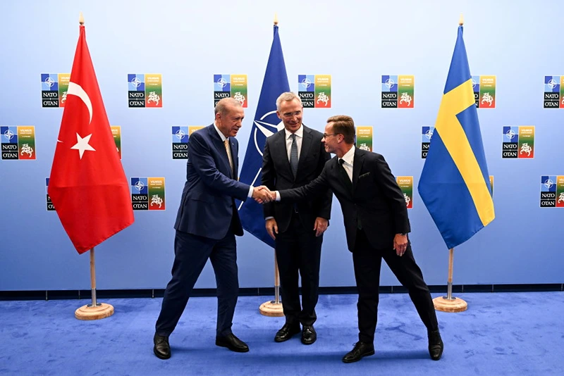 VILNIUS, LITHUANIA - JULY 10: Turkish President Recep Tayyip Erdogan (L) shakes hands with Swedish Prime Minister Ulf Kristersson (R) as the Secretary General of NATO Jens Stoltenberg (C) looks on during their meeting ahead of the NATO Summit on July 11, 2023 in Vilnius, Lithuania. The summit is bringing together NATO members and partner countries heads of state from July 11-12 to chart the alliance's future, with Sweden's application for membership and Russia's ongoing war in Ukraine as major topics on the summit agenda. (Photo by Filip Singer - Pool/Getty Images)