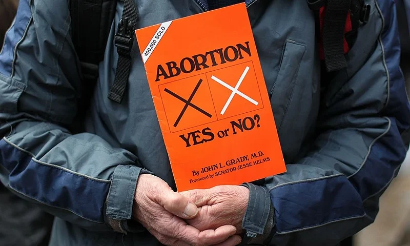 A anti abortion protestors holds up placards outside the Marie Stopes clinic, the first private clinic to offer abortions to women in Belfast, Northern Ireland on October 18, 2012. Dozens of pro-life campaigners protested outside the first abortion clinic in Northern Ireland as it opened to the public. Around 50 protesters brandishing placards saying "Life is precious" and showing photographs of foetuses gathered outside the privately run clinic in an anonymous building in Belfast. AFP PHOTO/ Peter Muhly (Photo credit should read PETER MUHLY/AFP via Getty Images)