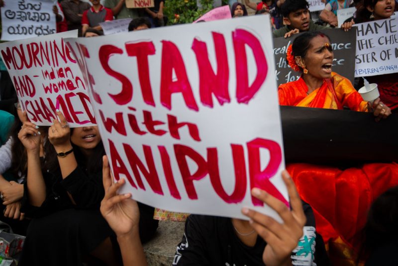 People shout slogans during a protest against violence in the northeastern Indian state of Manipur, on July 21, 2023 in Bengaluru, India. Outrage erupted across the country after grainy mobile phone footage of two Kuki tribal women who were forcibly stripped naked, paraded and gang raped by a mob of the majority Meitei tribal group went viral on social media forcing the Indian prime minister Narendra Modi to break his months long silence on the ethnic conflict in the northeastern state of Manipur that has so far claimed over 140 lives. (Photo by Abhishek Chinnappa/Getty Images)