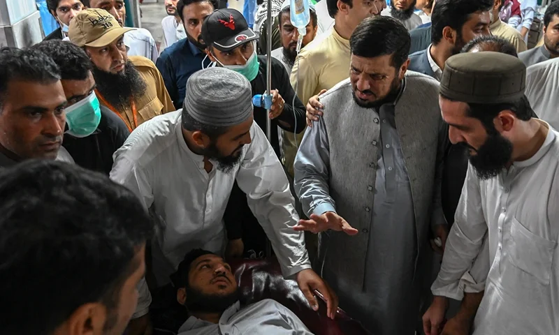 TOPSHOT-PAKISTAN-BLAST TOPSHOT - Haji Ghulam Ali (2nd R), governor of KP province greets an injured man in a hospital in Peshawar on July 30, 2023, after at least 44 people were killed and dozens more wounded by a suicide bombing at a political gathering of a leading Islamic party in northwest Pakistan. The blast targeted the Jamiat Ulema-e-Islam-F (JUI-F) party -- a government coalition partner led by an influential firebrand cleric -- as hundreds of supporters congregated under a canopy in the town of Khar, near the Afghan border. (Photo by Abdul MAJEED / AFP) (Photo by ABDUL MAJEED/AFP via Getty Images)
