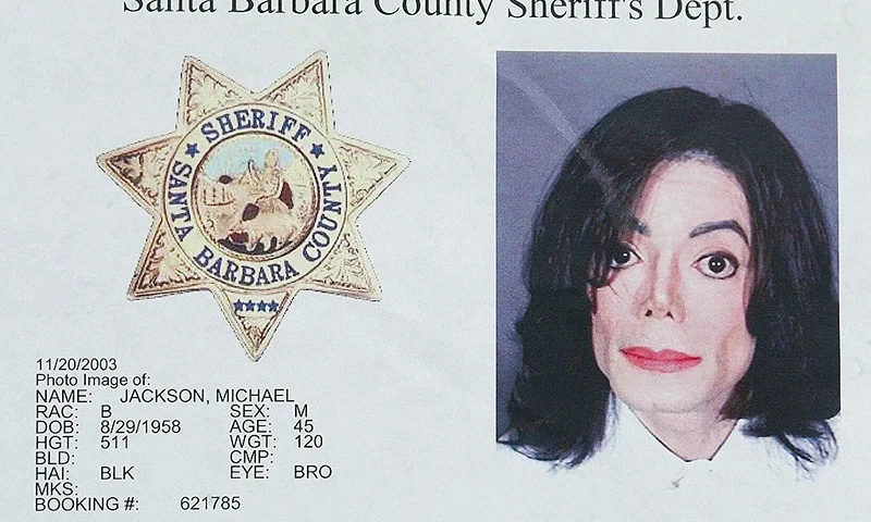 SANTA BARBARA, UNITED STATES: (FILES)This photo shows a police mug shot taken of US pop star Michael Jackson at the Santa Barbara Sheriff's booking office in Santa Barbara, California after Jackson surrendered himself there, 20 November 2003. Jackson was booked on suspicion of child molestation and released on three million USD bail. Jackson will be formally charged with child molestation on 18 or 19 December 2003, nearly a month after his dramatic arrest, the chief prosecutor said 16 December. The long-awaited charges against the "King of Pop," who turned himself in to police on 20 November on "multiple counts" of sex abuse on a child under 14, will be filed in the California town of Santa Maria, near his Neverland ranch."Charges against Michael Jackson will be filed at Santa Barbara County Superior Court, Santa Maria Division", District Attorney Tom Sneddon said. AFP PHOTO/Robyn BECK (Photo credit should read ROBYN BECK/AFP via Getty Images)