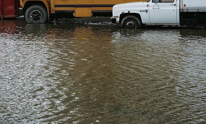 BLOONSBURG, PA - JUNE 29: A school bus and truck sit in standing water after flooding June 29, 2006 in Bloomsburg, Pennsylvania. Many homes in Bloomsburg had water lap into their first floor, filling their basements and ruining carpet and low-lying household items. (Photo by Chris Hondros/Getty Images)
