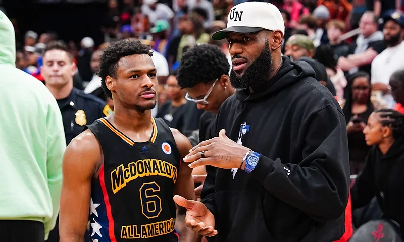HOUSTON, TEXAS - MARCH 28: Bronny James #6 of the West team talks to Lebron James of the Los Angeles Lakers after the 2023 McDonald's High School Boys All-American Game at Toyota Center on March 28, 2023 in Houston, Texas. (Photo by Alex Bierens de Haan/Getty Images)