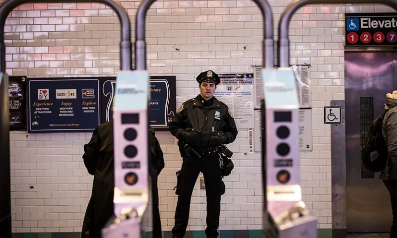 NEW YORK, NY - DECEMBER 11: A New York City Police Department officer stands watch at the entrance to the Times Square subway station during the evening rush hour, December 11, 2017 in New York City. The Police Department said that one person, Akayed Ullah, is in custody for an attempted terror attack after an explosion in a passageway linking the Port Authority Bus Terminal with the subway. (Photo by Drew Angerer/Getty Images)