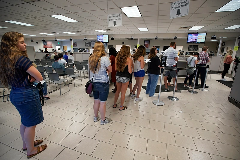 OREM, UT - JULY 09: People wait in line at the Driver License Division for the state of Utah on July 9, 2019 in Orem, Utah. Documents recently made public show that the FBI and Immigration and Customs Enforcement (ICE) have made thousands of searches in Department of Motor Vehicle databases using facial recognition technology in at least three states including Utah, Vermont and Washington State. (Photo by George Frey/Getty Images)
