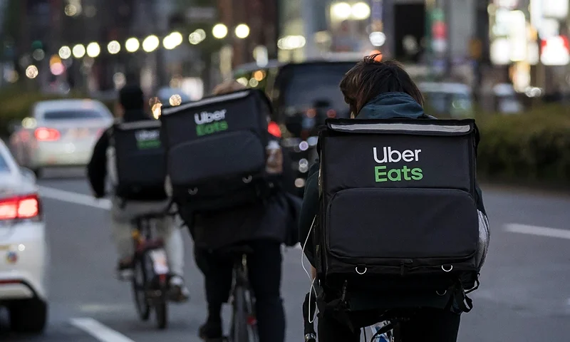 TOKYO, JAPAN - APRIL 11: Uber Eats delivery men ride bicycles through the Kabukicho entertainment area on April 11, 2020 in Tokyo, Japan. Tokyo Governor Yuriko Koike has requested that businesses including schools, athletic facilities, bars and restaurants to temporarily close or operate under reduced hours. The action follows a state of emergency that covers 7 of Japans 47 prefectures as the Covid-19 coronavirus outbreak continues to spread throughout the country. (Photo by Tomohiro Ohsumi/Getty Images)