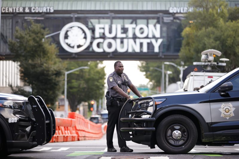 A sheriff's deputy looks on near the Fulton County Courthouse, Monday, Aug. 14, 2023, in Atlanta. Court officials in Atlanta published a list of criminal charges against former President Donald Trump. But as a Fulton County grand jury began hearing from witnesses Monday, there was no public indication that Trump had been indicted in a long-running investigation of the 2020 presidential election. The list was later deleted. (AP Photo/Alex Slitz)