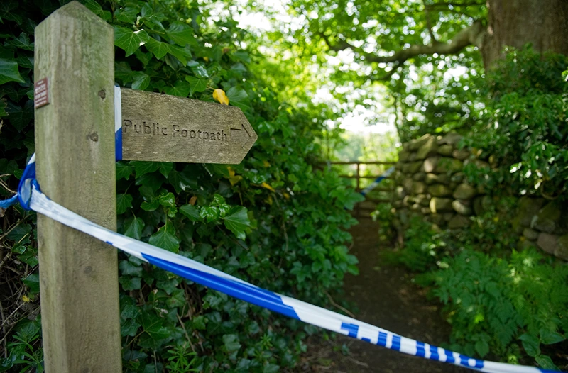 Police tape marks off a public footpath
Police tape marks off a public footpath in a wooded area in Boot, near Seascale in Cumbria, north-west England, on June 3, 2010. Friends and neighbours of Derrick Bird, whose body was found in a wooded area of Boot after he killing 12 people on a shooting spree in northern England on Tuesday June 12, 2010, have expressed shock that a "normal bloke" could wreak such devastation. AFP PHOTO/Leon Neal (Photo credit should read LEON NEAL/AFP via Getty Images)