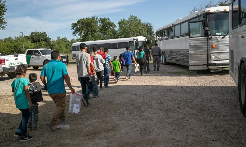 US Border Patrol Receives Asylum Seekers In Texas' Rio Grande Valley LOS EBANOS, TEXAS - JULY 02: Immigrants walk to U.S. Homeland Security busses to be transferred to a U.S. Border Patrol facility in McAllen after crossing from Mexico on July 02, 2019 in Los Ebanos, Texas. Hundreds of immigrants, most from Central America, turned themselves in to Border Patrol agents after rafting across the Rio Grande from Mexico to seek political asylum in the United States. (Photo by John Moore/Getty Images)