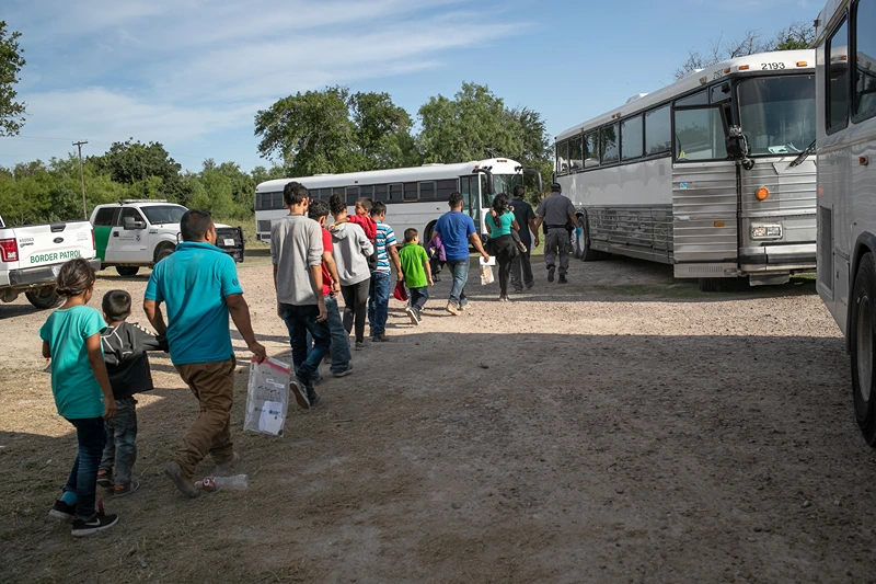 US Border Patrol Receives Asylum Seekers In Texas' Rio Grande Valley
LOS EBANOS, TEXAS - JULY 02: Immigrants walk to U.S. Homeland Security busses to be transferred to a U.S. Border Patrol facility in McAllen after crossing from Mexico on July 02, 2019 in Los Ebanos, Texas. Hundreds of immigrants, most from Central America, turned themselves in to Border Patrol agents after rafting across the Rio Grande from Mexico to seek political asylum in the United States. (Photo by John Moore/Getty Images)