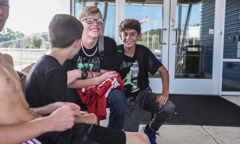 Some boys have a laugh near the high school on September 10, 2019 in Manchester, Ohio. The community of Manchester has been negatively impacted by the closing of two local coal burning generating plants, Killen Station and J.M. Stuart Station that provided jobs and a tax base. (Photo by Stephanie Keith/Getty Images)