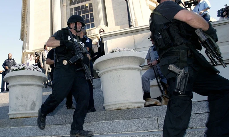 TOPSHOT - US Capitol Police SWAT members walk out of the Cannon House Office Building after a reported gun was seen in the US Capitol Building 30 October 2003 in Washington, DC. The security scare as it turned out, was caused by a toy gun being brought into a congressional office building as part of a Halloween costume, a police spokesman said. AFP PHOTO/Stephen JAFFE (Photo by STEPHEN JAFFE / AFP) (Photo by STEPHEN JAFFE/AFP via Getty Images)