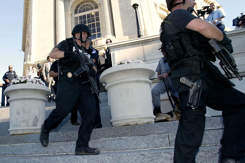 TOPSHOT - US Capitol Police SWAT members walk out of the Cannon House Office Building after a reported gun was seen in the US Capitol Building 30 October 2003 in Washington, DC. The security scare as it turned out, was caused by a toy gun being brought into a congressional office building as part of a Halloween costume, a police spokesman said. AFP PHOTO/Stephen JAFFE (Photo by STEPHEN JAFFE / AFP) (Photo by STEPHEN JAFFE/AFP via Getty Images)