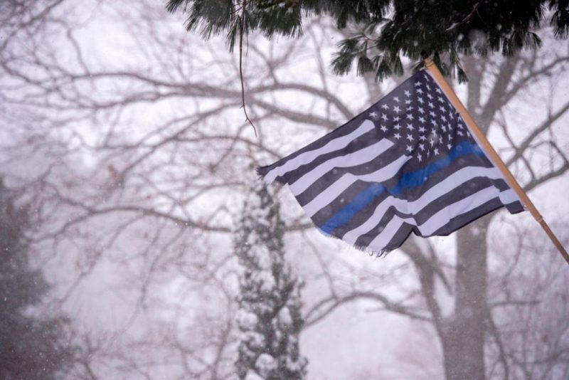 A Blue Lives Matter flag waves in the snow and wind in Saugus, Massachusetts during a winter storm in Saugus,Massachusetts on December 17, 2020. - A major snowstorm hit the US east coast during Thursday's early hours, creating extra challenges in the midst of a coronavirus pandemic and a mass vaccination rollout taking place across the region.The winter storm, moving over New York, Pennsylvania and other northeastern states, leaves millions facing more than a foot of snow a week before Christmas, potentially disrupting coronavirus testing and delaying holiday deliveries. It also left more than 60 million people under bad weather warnings from Maine to South Carolina. (Photo by Joseph Prezioso / AFP) (Photo by JOSEPH PREZIOSO/AFP via Getty Images)