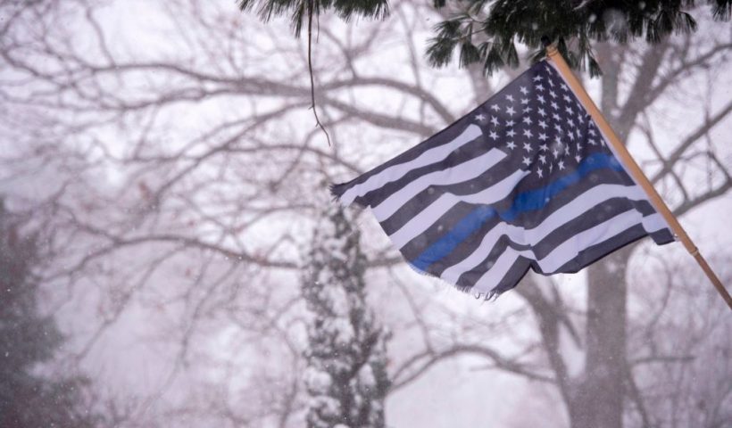 A Blue Lives Matter flag waves in the snow and wind in Saugus, Massachusetts during a winter storm in Saugus,Massachusetts on December 17, 2020. - A major snowstorm hit the US east coast during Thursday's early hours, creating extra challenges in the midst of a coronavirus pandemic and a mass vaccination rollout taking place across the region.The winter storm, moving over New York, Pennsylvania and other northeastern states, leaves millions facing more than a foot of snow a week before Christmas, potentially disrupting coronavirus testing and delaying holiday deliveries. It also left more than 60 million people under bad weather warnings from Maine to South Carolina. (Photo by Joseph Prezioso / AFP) (Photo by JOSEPH PREZIOSO/AFP via Getty Images)