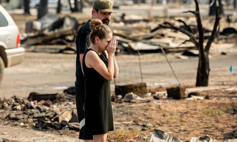 TOPSHOT - Riley Cantrell (R) cries while she and her boyfriend Bradley Fairbanks (L) view her mother's home that burned during the Dixie fire in Greenville, California on September 4, 2021. - The Cantrell's family dog died at the home and was buried by firefighters who later found it. The Dixie fire destroyed most of the town of Greenville, California and still continues to burn. (Photo by JOSH EDELSON / AFP) (Photo by JOSH EDELSON/AFP via Getty Images)