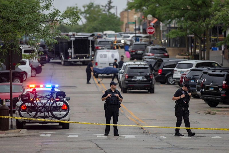HIGHLAND PARK, IL - JULY 04: First responders take away victims from the scene of a mass shooting at a Fourth of July parade on July 4, 2022 in Highland Park, Illinois. At least six people were killed and 19 injured, according to published reports. (Photo by Jim Vondruska/Getty Images)