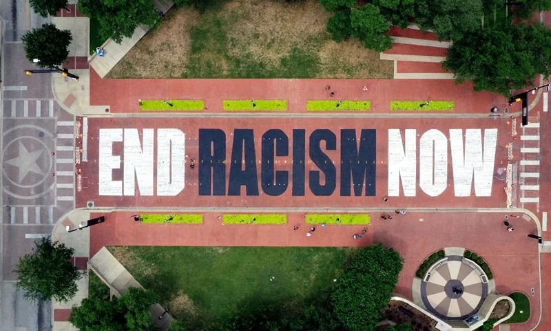 FORT WORTH, TEXAS - JUNE 28: An aerial view from a drone as residents view the "End Racism Now" mural painted on Main Street in downtown on June 28, 2020 in Fort Worth, Texas. Local artists partnered with volunteers to paint the message after being inspired by the Black Lives Matter movement and recent protest following the death of George Floyd. (Photo by Tom Pennington/Getty Images)
