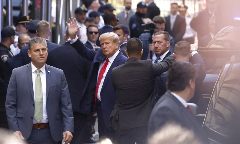 NEW YORK, NEW YORK - APRIL 04: Former U.S. President Donald Trump waves as he arrives at the Manhattan Criminal Court on April 04, 2023 in New York, New York. Trump will be arraigned during his first court appearance today following an indictment by a grand jury that heard evidence about money paid to adult film star Stormy Daniels before the 2016 presidential election. With the indictment, Trump becomes the first former U.S. president in history to be charged with a criminal offense. (Photo by Kena Betancur/Getty Images)