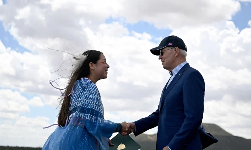 US-POLITICS-ENVIRONMENT-BIDEN Maya Tilousi, member of the Hopi Tribe, Havasupai Tribe of Grand Canyon, and the Cheyanne and Arapaho Tribes, shakes hands with US President Joe Biden at Red Butte Airfield, 25 miles (40kms) south of Tusayan, Arizona, on August 8, 2023. Biden announced he is putting the brakes on uranium mining around the Grand Canyon. Biden will give an area of nearly one million acres (404,686 hectares) "national monument" status. (Photo by Jim WATSON / AFP) (Photo by JIM WATSON/AFP via Getty Images)