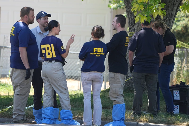 Suspect Shot In FBI Raid Reportedly Connected To President Biden Threats In Utah
PROVO, UTAH - AUGUST 9: FBI officials and other law enforcement officers stand outside the home of Craig Robertson who was shot and killed by the FBI in a raid on his home this morning on August 9, 2023 in Provo, Utah. The FBI was investigating alleged threats by Robertson to President Biden who is visiting Salt Lake City today and tomorrow. (Photo by George Frey/Getty Images)