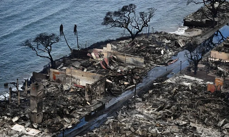 An aerial image taken on August 10, 2023 shows destroyed homes and buildings burned to the ground in Lahaina in the aftermath of wildfires in western Maui, Hawaii. At least 36 people have died after a fast-moving wildfire turned Lahaina to ashes, officials said August 9, 2023 as visitors asked to leave the island of Maui found themselves stranded at the airport. The fires began burning early August 8, scorching thousands of acres and putting homes, businesses and 35,000 lives at risk on Maui, the Hawaii Emergency Management Agency said in a statement. (Photo by Patrick T. Fallon / AFP) (Photo by PATRICK T. FALLON/AFP via Getty Images)