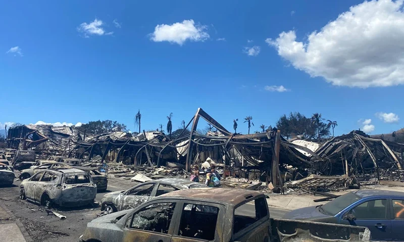 TOPSHOT - Burned cars, destroyed buildings and homes are pictured in the aftermath of a wildfire in Lahaina, western Maui, Hawaii on August 11, 2023. A wildfire that left Lahaina in charred ruins has killed at least 55 people, authorities said on August 10, making it one of the deadliest disasters in the US state's history. Brushfires on Maui, fueled by high winds from Hurricane Dora passing to the south of Hawaii, broke out August 8 and rapidly engulfed Lahaina. (Photo by Paula RAMON / AFP) / "The erroneous mention[s] appearing in the metadata of this photo by Paula RAMON has been modified in AFP systems in the following manner: [August 11] instead of [Auguat 10]. Please immediately remove the erroneous mention[s] from all your online services and delete it (them) from your servers. If you have been authorized by AFP to distribute it (them) to third parties, please ensure that the same actions are carried out by them. Failure to promptly comply with these instructions will entail liability on your part for any continued or post notification usage. Therefore we thank you very much for all your attention and prompt action. We are sorry for the inconvenience this notification may cause and remain at your disposal for any further information you may require." (Photo by PAULA RAMON/AFP via Getty Images)