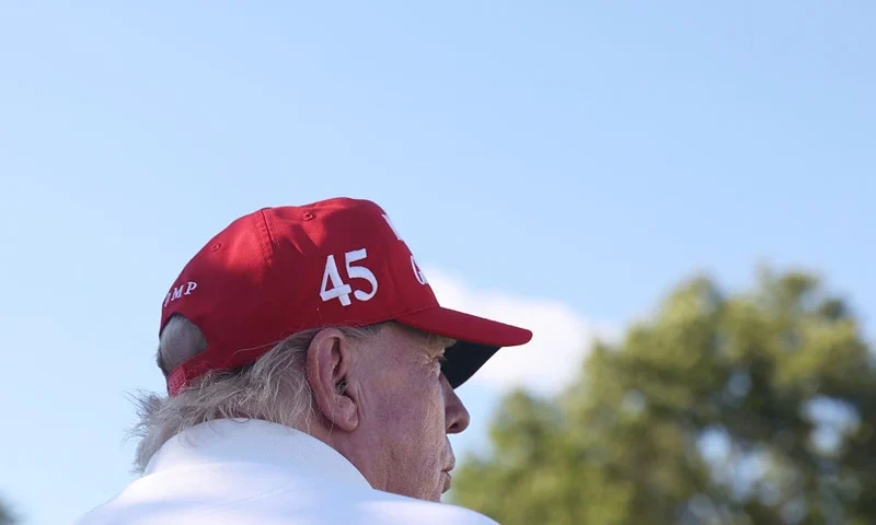 BEDMINSTER, NEW JERSEY - AUGUST 13: Former President Donald Trump signs autographs hits his shot from the 16th tee during day three of the LIV Golf Invitational - Bedminster at Trump National Golf Club on August 13, 2023 in Bedminster, New Jersey. (Photo by Mike Stobe/Getty Images)