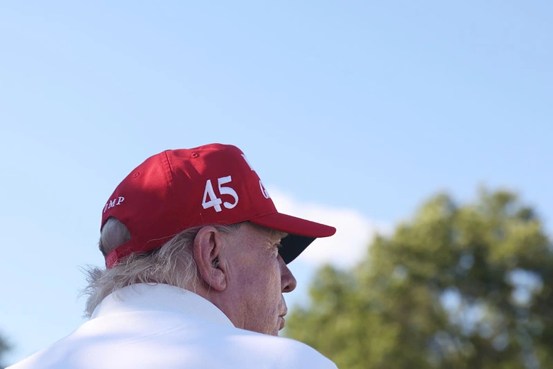 BEDMINSTER, NEW JERSEY - AUGUST 13: Former President Donald Trump signs autographs hits his shot from the 16th tee during day three of the LIV Golf Invitational - Bedminster at Trump National Golf Club on August 13, 2023 in Bedminster, New Jersey. (Photo by Mike Stobe/Getty Images)