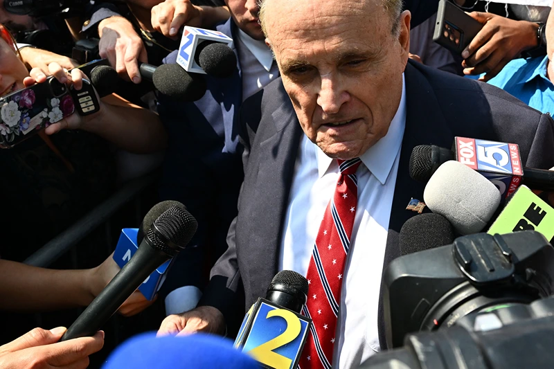 US-JUSTICE-POLITICS-TRUMP
Former New York City Mayor and attorney of former US President Donald Trump, Rudy Giuliani, speaks to members of the media after being booked, outside the Fulton County Jail in Atlanta, Georgia, on August 23, 2023. Giuliani, former US President Donald Trump, and 17 others were given until August 25, 2023 to surrender at the courthouse after being indicted on 41 counts related to their efforts to overturn the 2020 US Presidential election. (Photo by CHANDAN KHANNA / AFP) (Photo by CHANDAN KHANNA/AFP via Getty Images)