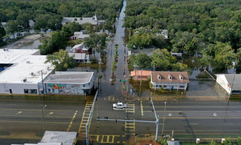 CRYSTAL RIVER, FLORIDA - AUGUST 30: In an aerial view, a vehicle drives through a flooded street in the downtown area after Hurricane Idalia passed offshore on August 30, 2023 in Crystal River, Florida. Hurricane Idalia hit the Big Bend area on the Gulf Coast of Florida as a Category 3 storm. (Photo by Joe Raedle/Getty Images)