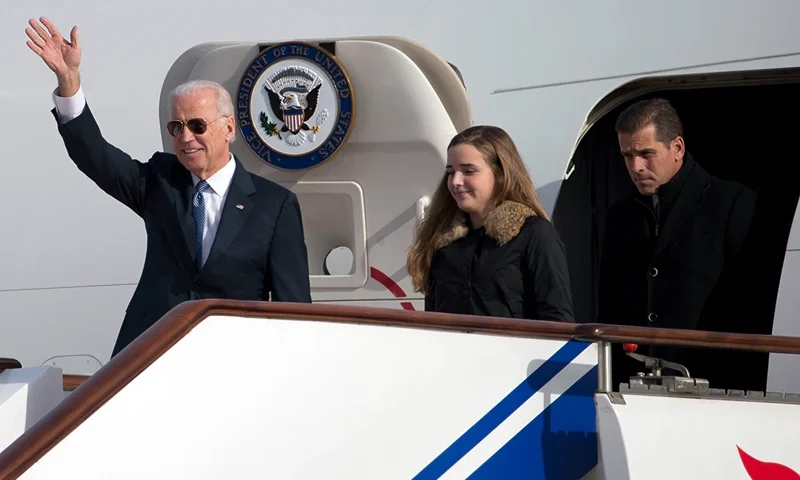 US Vice President Joe Biden waves as he walks out of Air Force Two with his granddaughter, Finnegan Biden (C) and son Hunter Biden (R) upon their arrival in Beijing on December 4, 2013. Biden arrived in Beijing on Decmber 4 amid rising friction over a Chinese air zone, needing to tread between bolstering ties with the rising power and underscoring alliances with Tokyo and Seoul. AFP PHOTO/POOL/Ng Han Guan (Photo credit should read NG HAN GUAN/AFP via Getty Images)