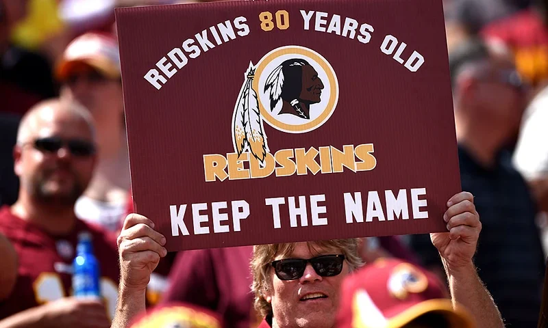 LANDOVER, MD - SEPTEMBER 14: A Washington Redskins fan holds up a sign to keep the Redskins name before they play the Jacksonville Jaguars at FedExField on September 14, 2014 in Landover, Maryland. The Washington Redskins won, 41-10. (Photo by Patrick Smith/Getty Images)
