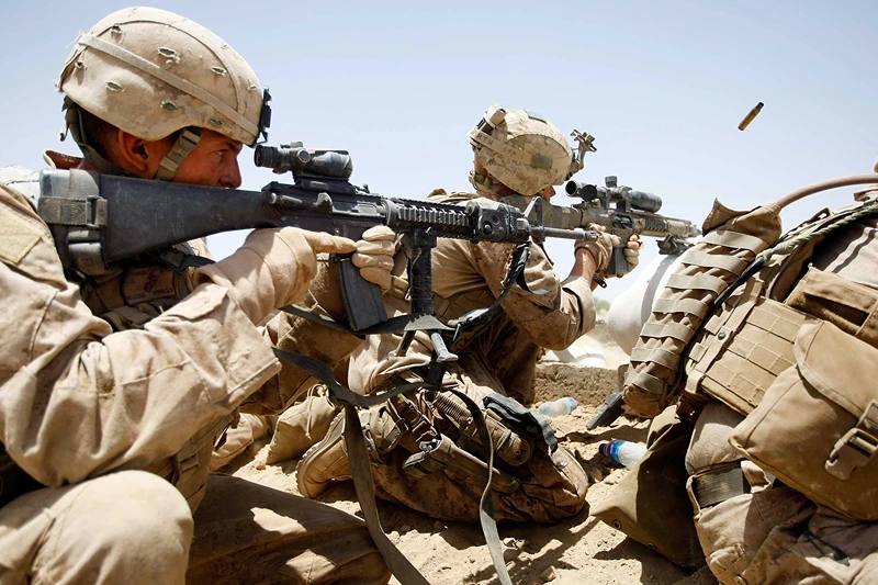 U.S. Marines Continue Suppression Of Insurgents
MAIN POSHTEH, AFGHANISTAN - JULY 3: U.S. Marines from 2nd Marine Expeditionary Brigade, RCT 2nd Battalion 8th Marines Echo Co. shoot at enemy targets during a firefight on July 3, 2009 in Main Poshteh, Afghanistan. The Marines are part of Operation Khanjari which was launched to take areas in the Southern Helmand Province that Taliban fighters are using as a supply route and to help the local Afghan population prepare for the upcoming presidential elections. (Photo by Joe Raedle/Getty Images)