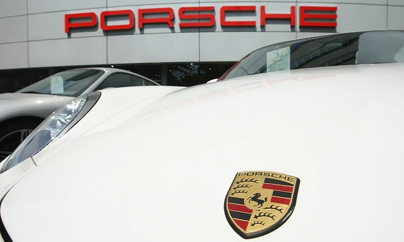 BERLIN - JULY 21: Sportscars of German automaker Porsche stand on display at a dealership on July 21, 2009 in Berlin, Germany. Another German carmaker, Volkswagen, is seeking to take over Porsche and has offered EUR 8 billion for an initial stake. Leaders of the two companies, including members of the two powerful Piech and Porsche families, who both have substantial stakes in the two companies, are to meet on Thursday to decide over the plan. Porsche is heavily in debt and the future for its CEO, Wendelin Wiedeking, is uncertain. (Photo by Sean Gallup/Getty Images)