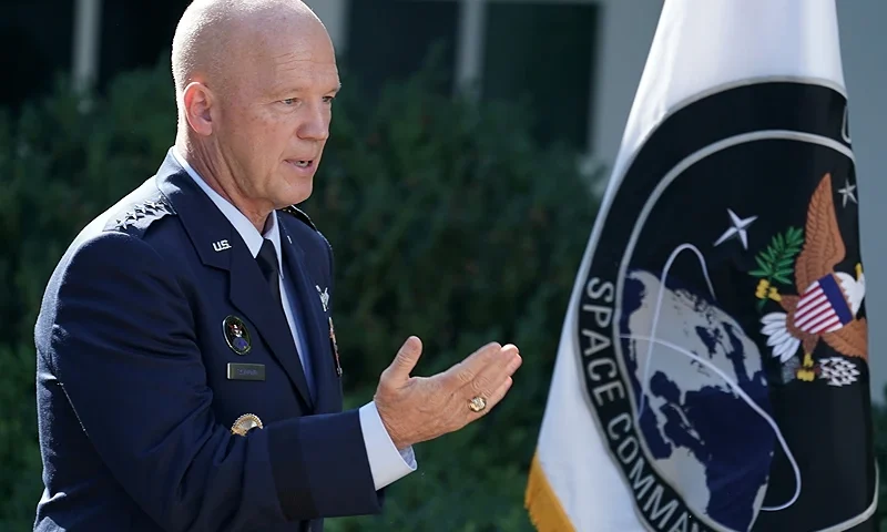 WASHINGTON, DC - AUGUST 29: U.S. Air Force Space Command Gen. John "Jay" Raymond stands next to the flag of the newly established U.S. Space Command, the sixth national armed service, in the Rose Garden at the White House August 29, 2019 in Washington, DC. Citing potential threats from China and Russia and the nation’s reliance on satellites for defense operations, Trump said the U.S. needs to launch a 'space force.' Raymond will serve as the first head of Space Command, which will have 87 active units handling operations such as missile warning, satellite surveillance, space control and space support. (Photo by Chip Somodevilla/Getty Images)