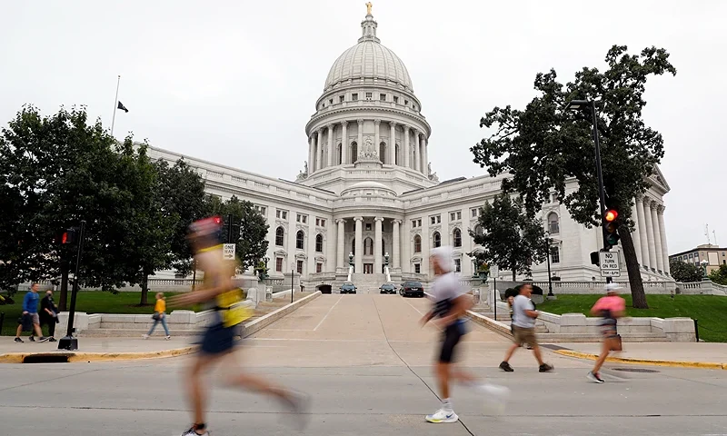 MADISON, WISCONSIN - SEPTEMBER 12: Athletes run past the Wisconsin Capitol building during the run portion of the IRONMAN Wisconsin on September 12, 2021 in Madison, Wisconsin. (Photo by Patrick McDermott/Getty Images for IRONMAN)
