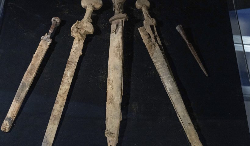 Israeli archaeologists show four Roman-era swords and a javelin head found during a recent excavation in a cave near the Dead Sea, in Jerusalem, Wednesday, Sep. 6, 2023. Archaeologists said the exceptionally preserved artifacts are dated to the 2nd century, when Jewish rebels launched an uprising against the Roman Empire. (AP Photo/Ohad Zwigenberg)