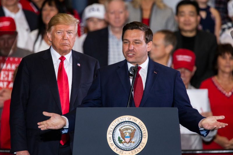 PENSACOLA, FL - NOVEMBER 03: Florida Republican gubernatorial candidate Ron DeSantis speaks with U.S. President Donald Trump at a campaign rally at the Pensacola International Airport on November 3, 2018 in Pensacola, Florida. President Trump is campaigning in support of Republican candidates in the upcoming midterm elections. (Photo by Mark Wallheiser/Getty Images)