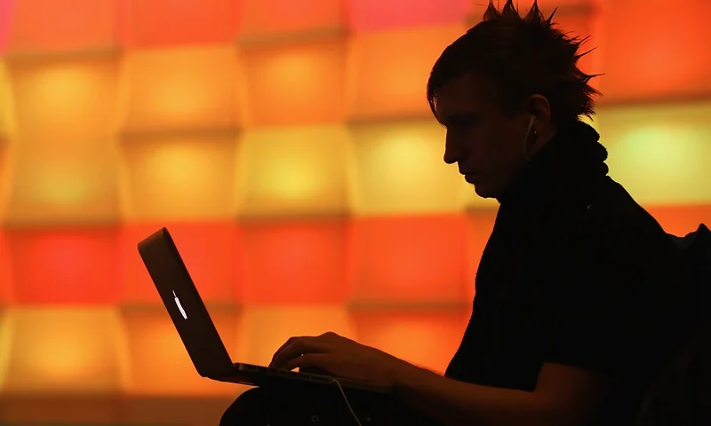 BERLIN, GERMANY - DECEMBER 28: A participant sits with a laptop computer as he attends the annual Chaos Communication Congress of the Chaos Computer Club at the Berlin Congress Center on December 28, 2010 in Berlin, Germany. The Chaos Computer Club is Europe's biggest network of computer hackers and its annual congress draws up to 3,000 participants. (Photo by Sean Gallup/Getty Images)