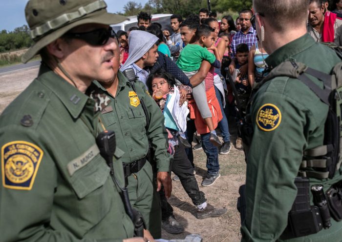LOS EBANOS, TEXAS - JULY 02: U.S. Border Patrol agents watch over immigrants after taking them into custody on July 02, 2019 in Los Ebanos, Texas. Hundreds of immigrants, most from Central America, turned themselves in to border agents after rafting across the Rio Grande from Mexico to seek political asylum in the United States. (Photo by John Moore/Getty Images)